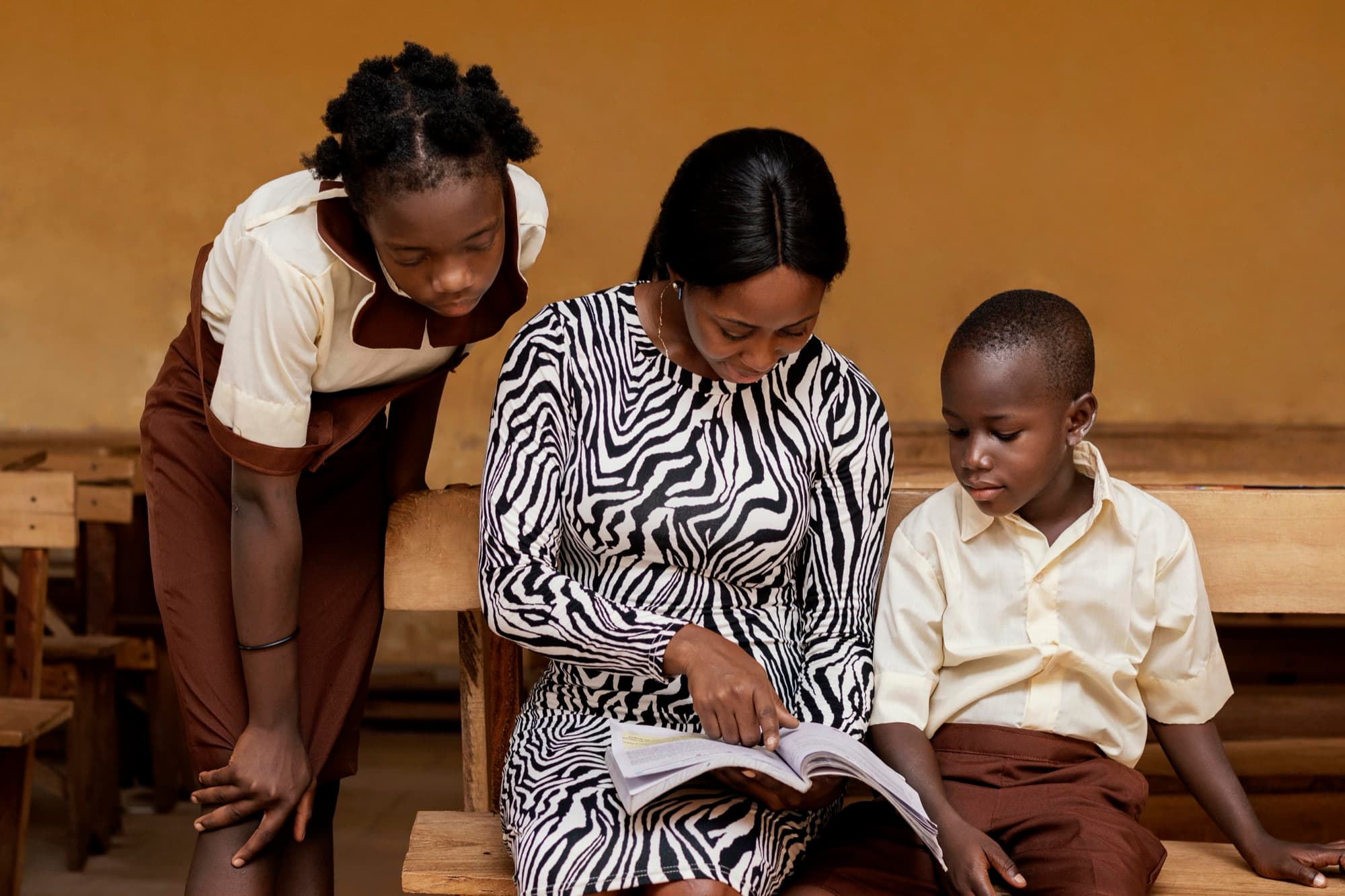 A Nigerian teacher helping her students in class